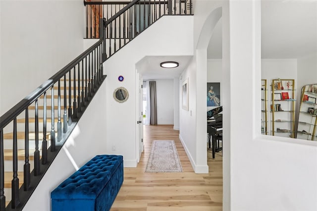 1802 Regal Mist Loop, Trinity, FL 34655 - staircase featuring wood finished floors and arched walkways
