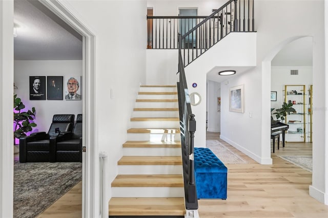 1802 Regal Mist Loop, Trinity, FL 34655 - stairway with arched walkways and wood finished floors
