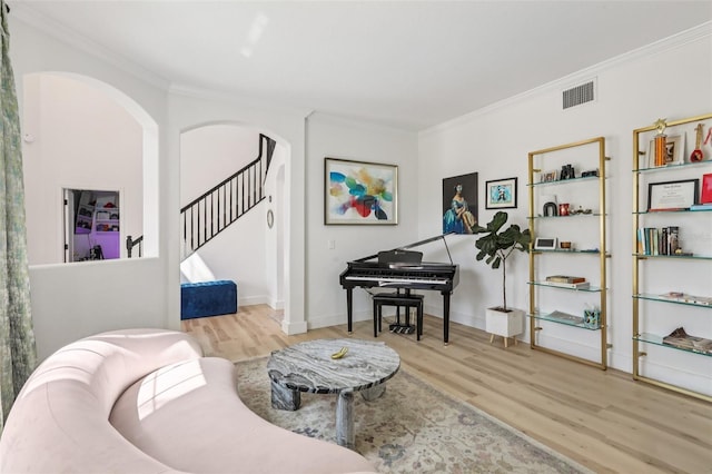 1802 Regal Mist Loop, Trinity, FL 34655 - living area with wood finished floors, crown molding, arched walkways, and stairway