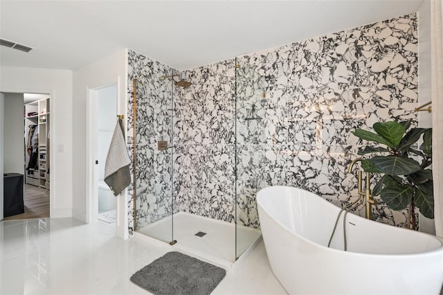 1802 Regal Mist Loop, Trinity, FL 34655 - full bathroom with a freestanding tub, a walk in closet, a stall shower, and tile patterned flooring