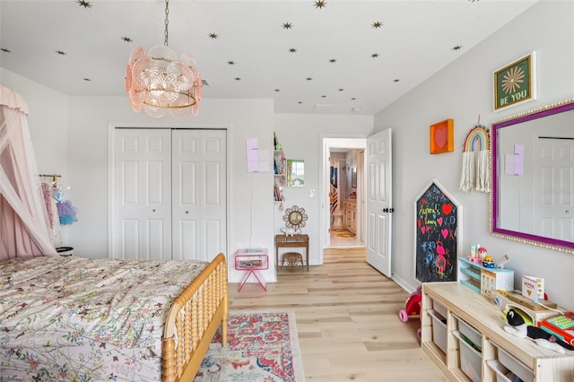 1802 Regal Mist Loop, Trinity, FL 34655 - bedroom featuring light wood-type flooring, a chandelier, and a closet