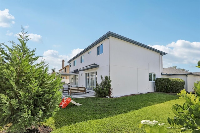1802 Regal Mist Loop, Trinity, FL 34655 - back of property with stucco siding and a lawn
