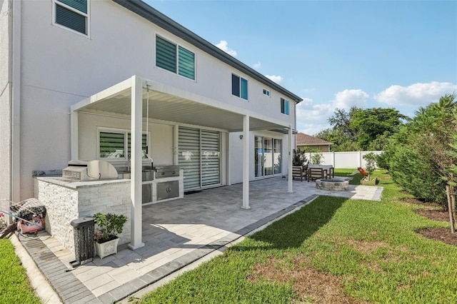 1802 Regal Mist Loop, Trinity, FL 34655 - rear view of property with an outdoor fire pit, area for grilling, stucco siding, and a patio
