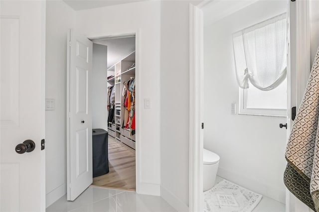 1802 Regal Mist Loop, Trinity, FL 34655 - bathroom with a spacious closet and tile patterned flooring