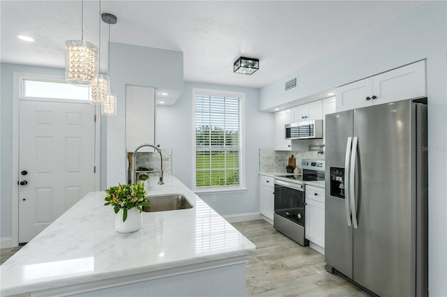 10520 White Lake Ct Unit 10520, Tampa, FL 33626 - kitchen with stainless steel appliances, white cabinetry, a chandelier, plenty of natural light, and recessed lighting