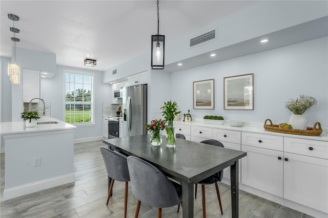 10520 White Lake Ct Unit 10520, Tampa, FL 33626 - dining area featuring light wood-style flooring and recessed lighting