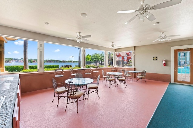 10520 White Lake Ct Unit 10520, Tampa, FL 33626 - view of patio / terrace with ceiling fan, outdoor dining area, and a water view