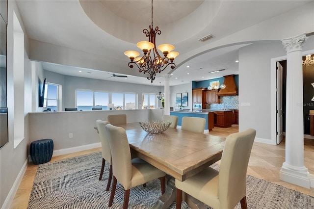 6418 Bright Bay Ct, Apollo Beach, FL 33572 - dining space featuring a chandelier, recessed lighting, arched walkways, light tile patterned flooring, and decorative columns