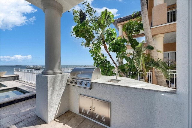 6418 Bright Bay Ct, Apollo Beach, FL 33572 - view of patio / terrace with exterior kitchen, an in-ground hot tub, and a water view