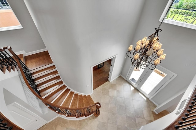 6418 Bright Bay Ct, Apollo Beach, FL 33572 - entryway with a chandelier, light tile patterned floors, and stairs
