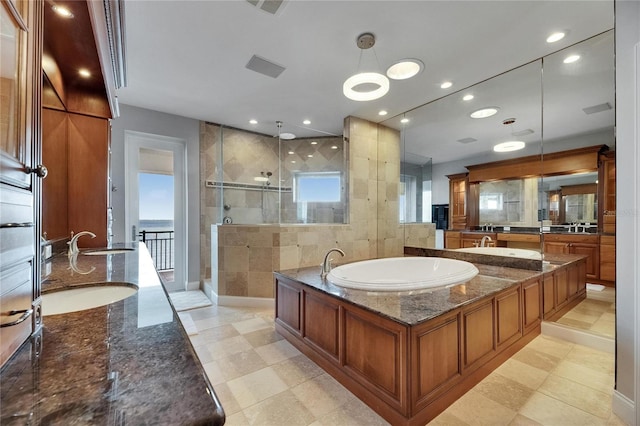 6418 Bright Bay Ct, Apollo Beach, FL 33572 - bathroom with double vanity, a stall shower, a garden tub, and recessed lighting