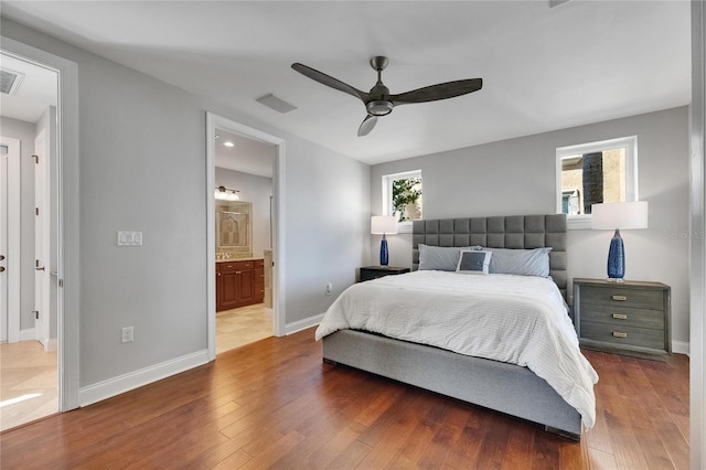 6418 Bright Bay Ct, Apollo Beach, FL 33572 - bedroom featuring wood finished floors, ensuite bath, and ceiling fan