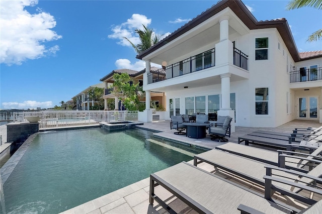 6418 Bright Bay Ct, Apollo Beach, FL 33572 - rear view of house featuring a balcony, a tiled roof, outdoor lounge area, a patio area, and a pool with connected hot tub