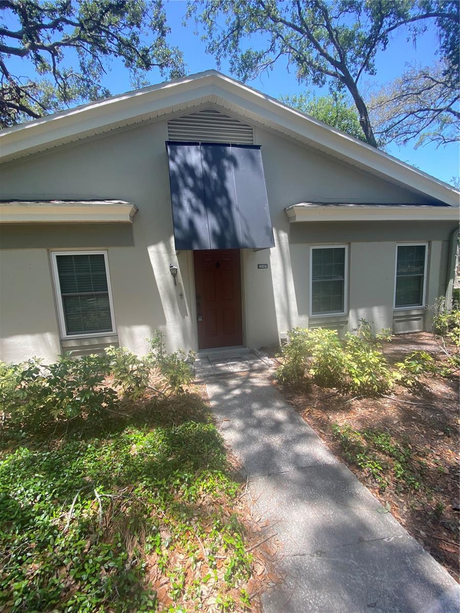 6214 Dewdrop Way Unit 621, Temple Terrace, FL 33617 - view of exterior entry featuring stucco siding