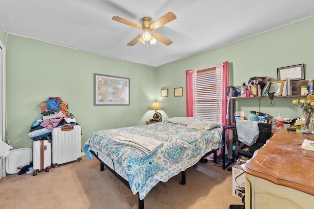 1955 Manatee Ct, Kissimmee, FL 34759 - bedroom featuring radiator heating unit, light carpet, and a ceiling fan