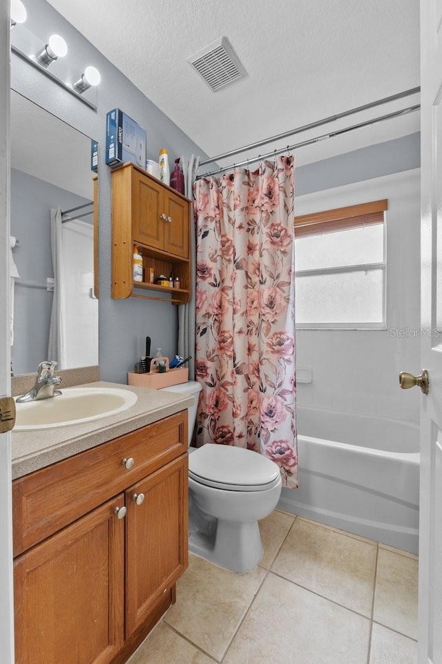 1955 Manatee Ct, Kissimmee, FL 34759 - bathroom featuring vanity, shower / tub combo with curtain, tile patterned floors, and a textured ceiling