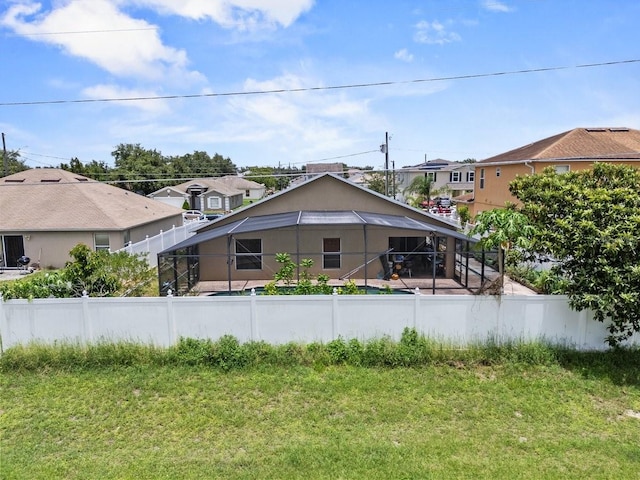 1955 Manatee Ct, Kissimmee, FL 34759 - back of house with a fenced backyard, a lanai, and a residential view