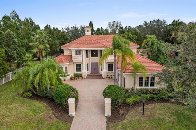 7803 Mathern Ct, Lakewood Ranch, FL 34202 - mediterranean / spanish-style house featuring decorative driveway, a tiled roof, a balcony, and stucco siding