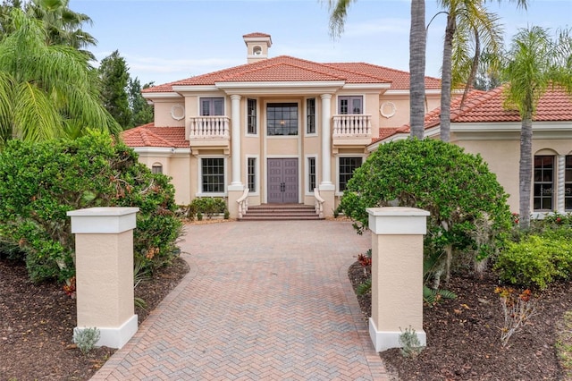 7803 Mathern Ct, Lakewood Ranch, FL 34202 - mediterranean / spanish-style home featuring a balcony, decorative driveway, stucco siding, and a tiled roof