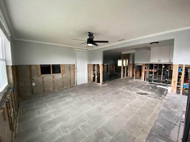 13931 King Ave, Hudson, FL 34667 - unfurnished living room featuring a ceiling fan and crown molding