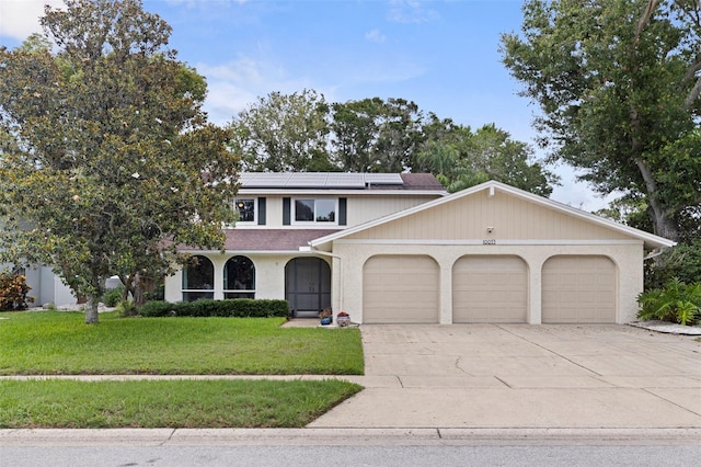 10053 W Bay St, Seminole, FL 33776 - view of front of house featuring a garage, driveway, a front lawn, solar panels, and a shingled roof