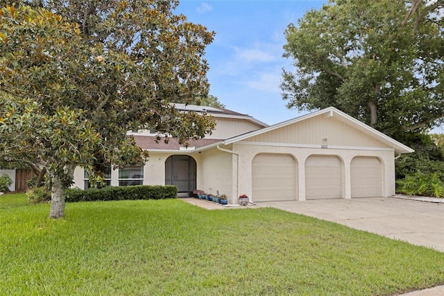 10053 W Bay St, Seminole, FL 33776 - view of front of home with a garage, a front yard, concrete driveway, a shingled roof, and stucco siding