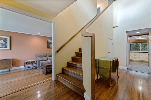10053 W Bay St, Seminole, FL 33776 - stairs with crown molding and wood finished floors