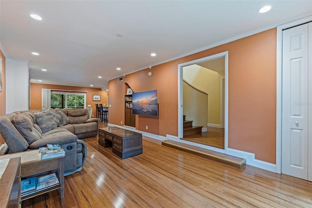 10053 W Bay St, Seminole, FL 33776 - living room with wood finished floors, crown molding, recessed lighting, and stairs