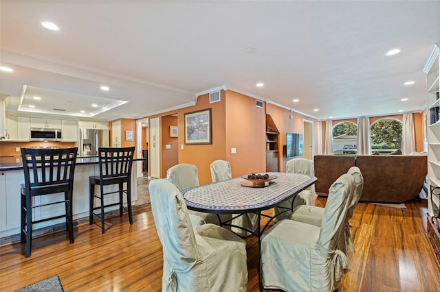 10053 W Bay St, Seminole, FL 33776 - dining area with light wood-style floors, recessed lighting, and ornamental molding
