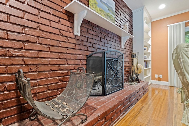 10053 W Bay St, Seminole, FL 33776 - detailed view of ornamental molding, wood finished floors, and a fireplace