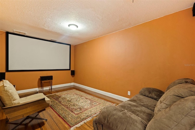 10053 W Bay St, Seminole, FL 33776 - home theater room featuring a textured ceiling and wood finished floors