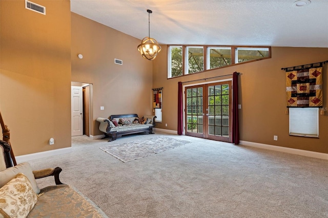 10053 W Bay St, Seminole, FL 33776 - living room with french doors, carpet flooring, a chandelier, and high vaulted ceiling