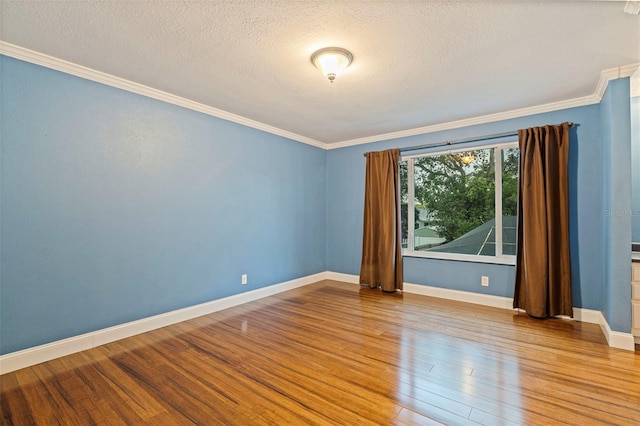 10053 W Bay St, Seminole, FL 33776 - spare room with crown molding, wood finished floors, and a textured ceiling