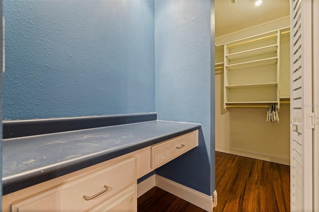 10053 W Bay St, Seminole, FL 33776 - spacious closet with dark wood-style floors and built in desk
