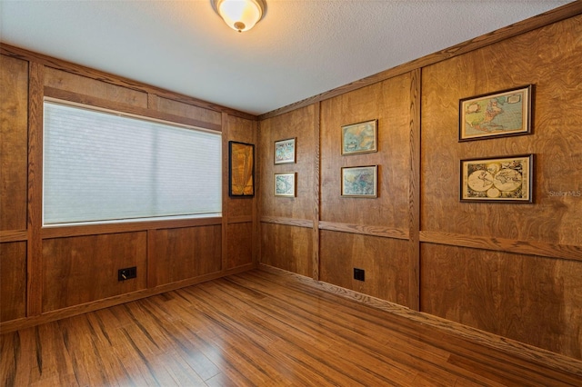 10053 W Bay St, Seminole, FL 33776 - spare room featuring hardwood / wood-style floors and wooden walls