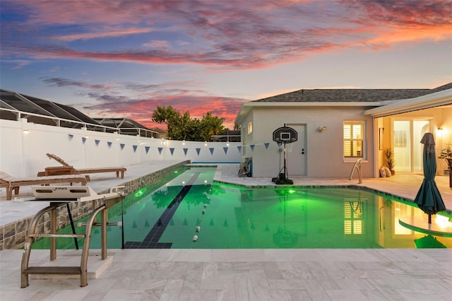 1631 Shady Oaks Dr, Oldsmar, FL 34677 - pool at dusk featuring a fenced backyard and a patio