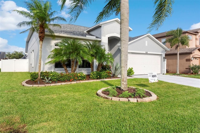 1631 Shady Oaks Dr, Oldsmar, FL 34677 - mediterranean / spanish-style house with stucco siding, concrete driveway, a garage, and roof with shingles