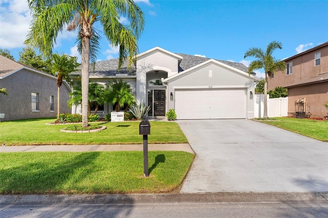 1631 Shady Oaks Dr, Oldsmar, FL 34677 - view of front of home featuring stucco siding, a garage, and driveway