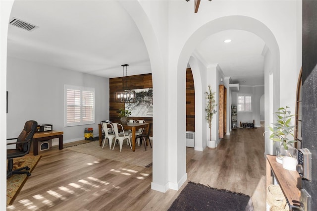 1631 Shady Oaks Dr, Oldsmar, FL 34677 - foyer featuring healthy amount of natural light, wood finished floors, ornamental molding, a chandelier, and radiator heating unit