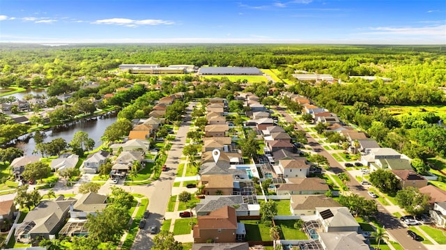 1631 Shady Oaks Dr, Oldsmar, FL 34677 - aerial perspective of suburban area featuring a heavily wooded area and a large body of water