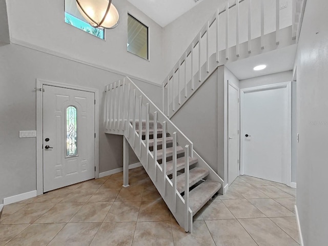 852 Village Way, Palm Harbor, FL 34683 - foyer entrance featuring light tile patterned floors, stairs, and a towering ceiling