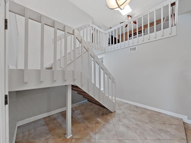 852 Village Way, Palm Harbor, FL 34683 - stairway featuring baseboards and tile patterned floors