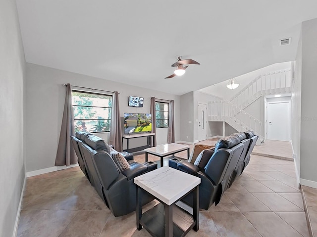852 Village Way, Palm Harbor, FL 34683 - living room featuring a ceiling fan, stairway, light tile patterned flooring, and lofted ceiling