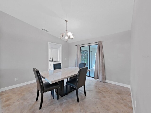852 Village Way, Palm Harbor, FL 34683 - dining room with a chandelier, lofted ceiling, and light tile patterned floors