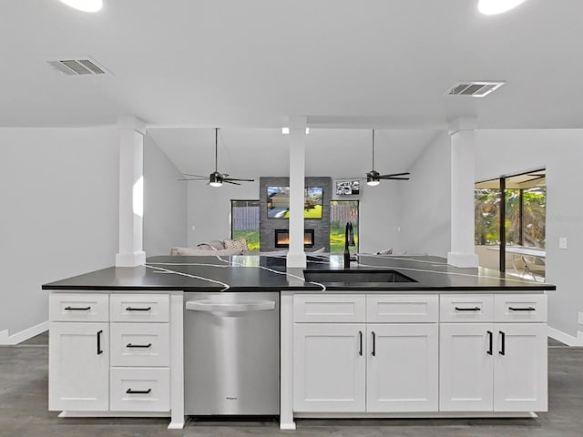 852 Village Way, Palm Harbor, FL 34683 - kitchen with stainless steel dishwasher, ceiling fan, a fireplace, dark countertops, and open floor plan