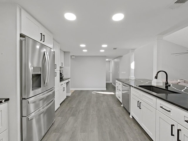 852 Village Way, Palm Harbor, FL 34683 - kitchen with appliances with stainless steel finishes, dark countertops, white cabinetry, and recessed lighting