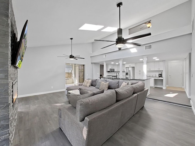 852 Village Way, Palm Harbor, FL 34683 - living area with ceiling fan, wood finished floors, a fireplace, recessed lighting, and high vaulted ceiling