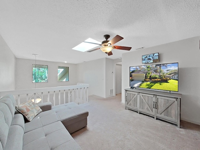 852 Village Way, Palm Harbor, FL 34683 - living area with a skylight, carpet, ceiling fan, and a textured ceiling