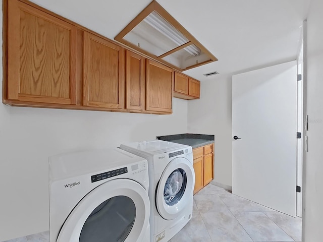 852 Village Way, Palm Harbor, FL 34683 - laundry area with cabinet space, washing machine and dryer, and light tile patterned floors