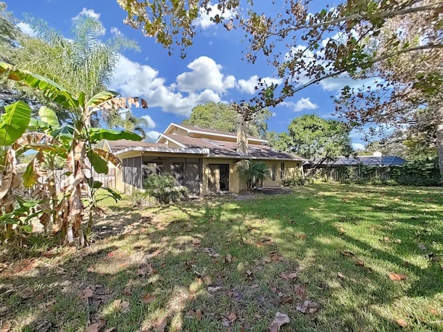 852 Village Way, Palm Harbor, FL 34683 - back of house with a sunroom and a yard